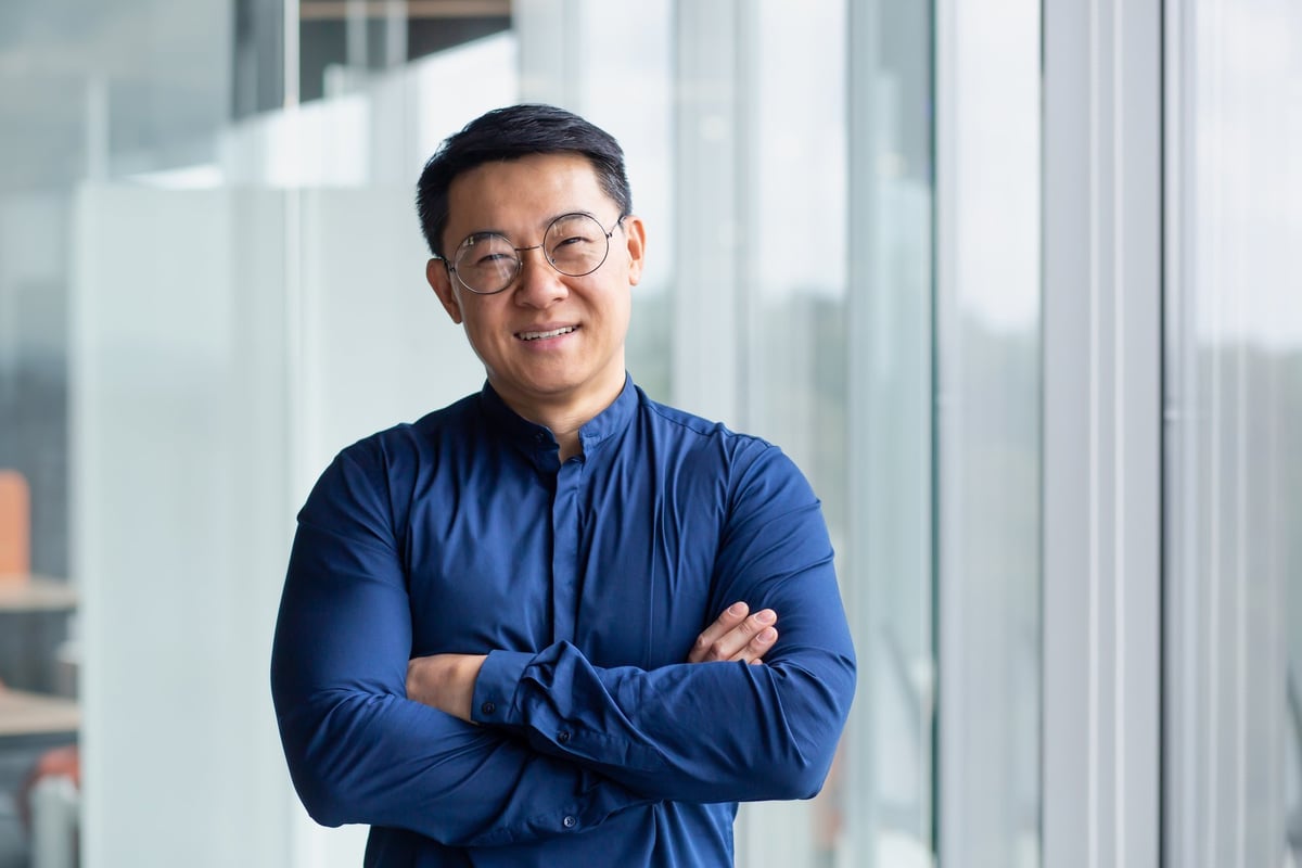 Portrait of successful mature boss, senior businessman in glasses Asian looking at camera